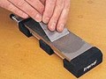TREND HEAVY DUTY BENCH HOLDER FOR DIAMOND STONES �19.05 Adjustable To Clamp 7\" Bench Stone Securely, (will Also Accept Most Oil Stones Up Yo 8\") Central Rubber Block Provides Extra Support.


